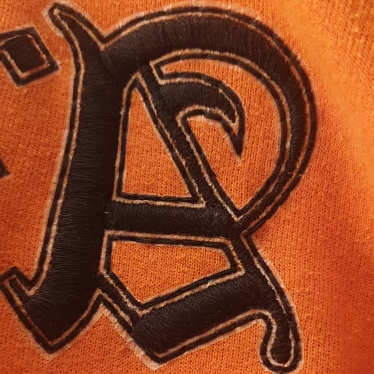 Close up on the mutiara embroidery showing the letter A